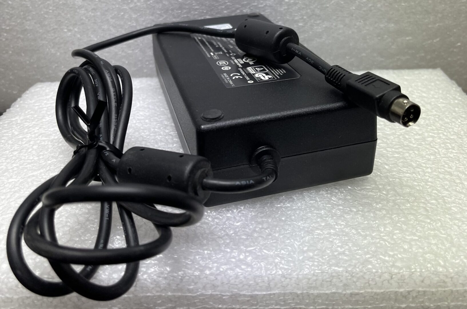 Black power adapter with attached cables.