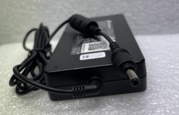 Black laptop power adapter with attached cable.